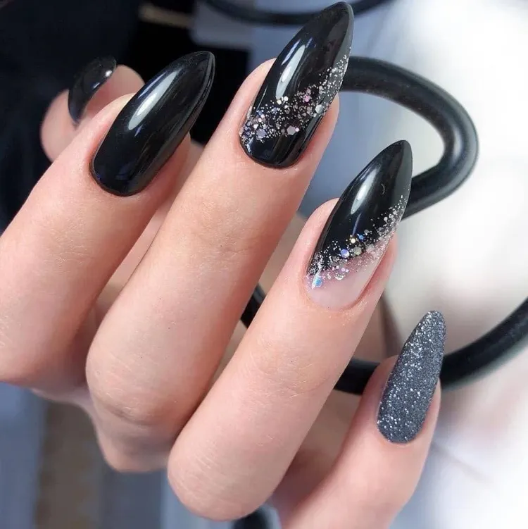 festive looking nail design black nails silver glitter nail polish modern manicure
