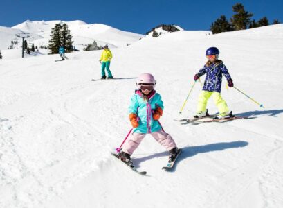 go skiing in the mountains children having fun during winter break