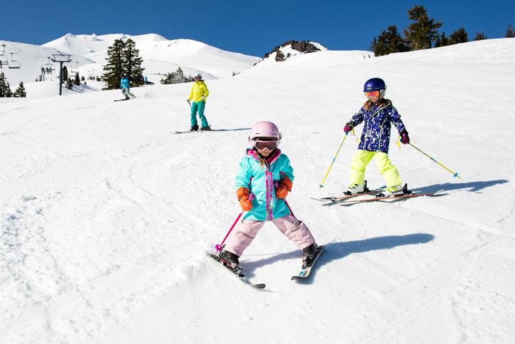 go skiing in the mountains children having fun during winter break