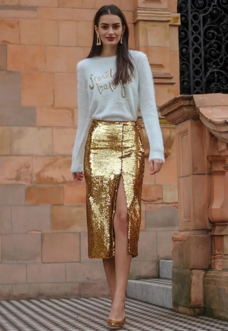 golden skirt with sequins with a white christmas sweater inspiration on what to wear for the holidays