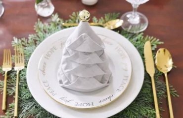 how to fold napkins for christmas eve grey christmas tree napkin fold with gold ornament and cutlery