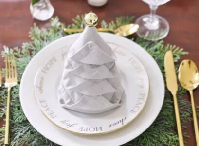 how to fold napkins for christmas eve grey christmas tree napkin fold with gold ornament and cutlery