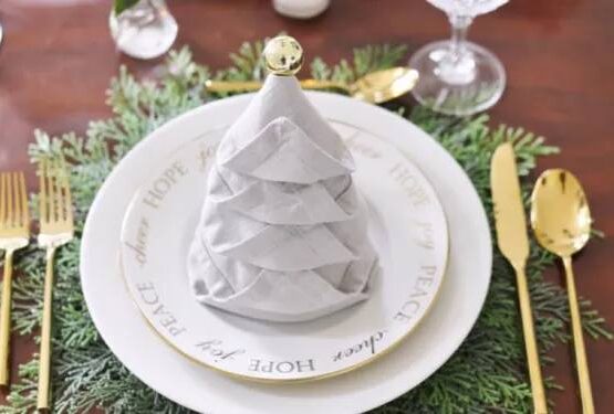 how to fold napkins for christmas eve grey christmas tree napkin fold with gold ornament and cutlery