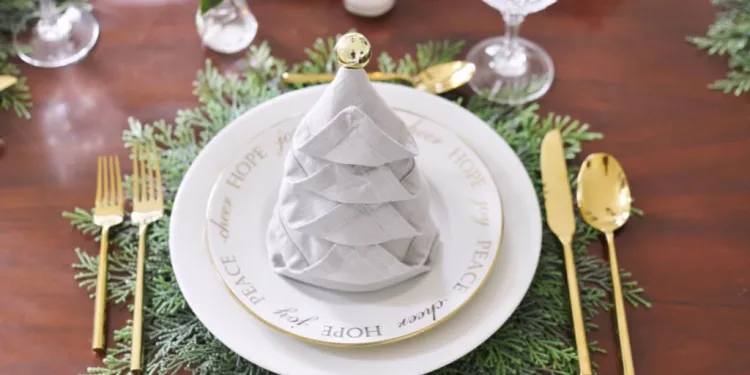 how to fold napkins for christmas eve grey christmas tree napkin fold with gold ornament and cutlery