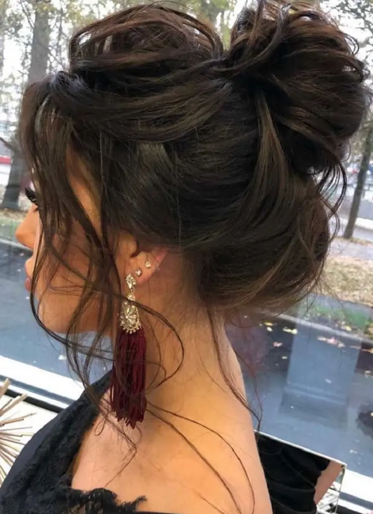 messy bun hairstyle for new years party brunette blonde long hair