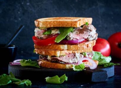 sandwich with roast beef and homemade mayonnaise tomatoes red onions toasted bread