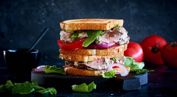 sandwich with roast beef and homemade mayonnaise tomatoes red onions toasted bread
