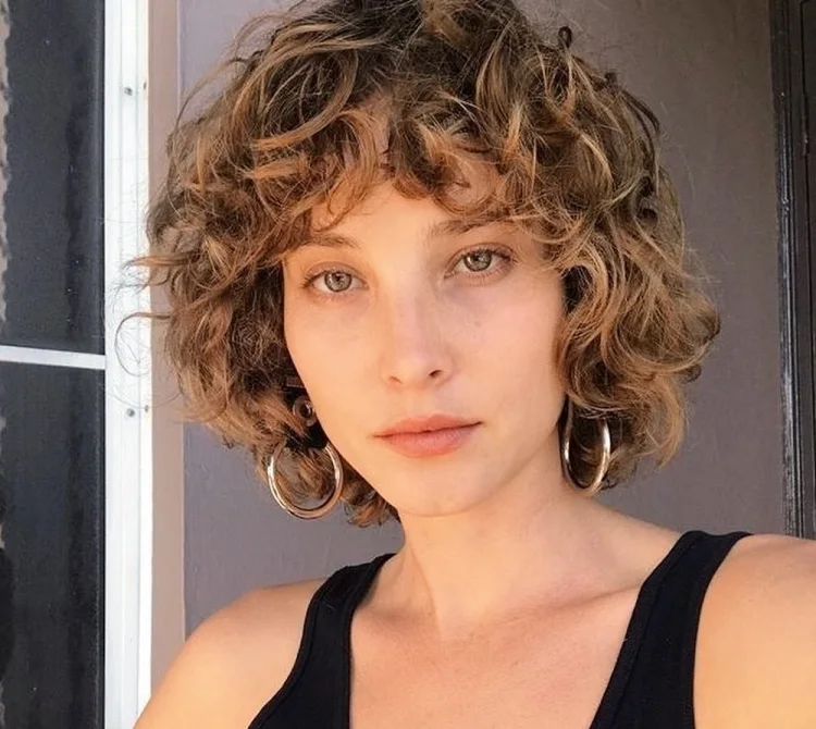 short curly hairstyle with textured bangs natural blonde hair hairstyle trends for 2023