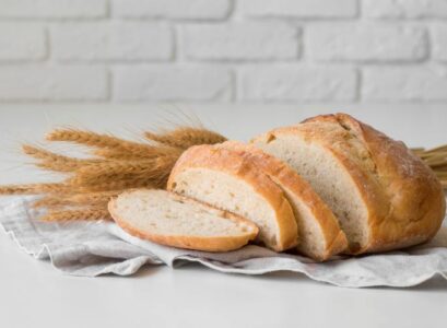 sliced fresh bread on cloth front view wheat flower