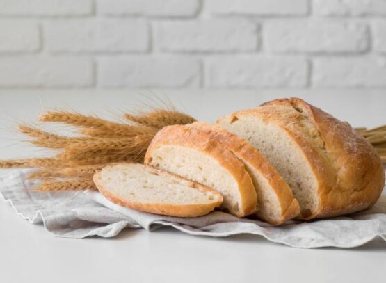 sliced fresh bread on cloth front view wheat flower