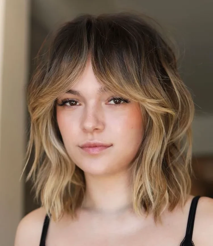 Trendy hairstyle 2023 layered bob with curtain bangs