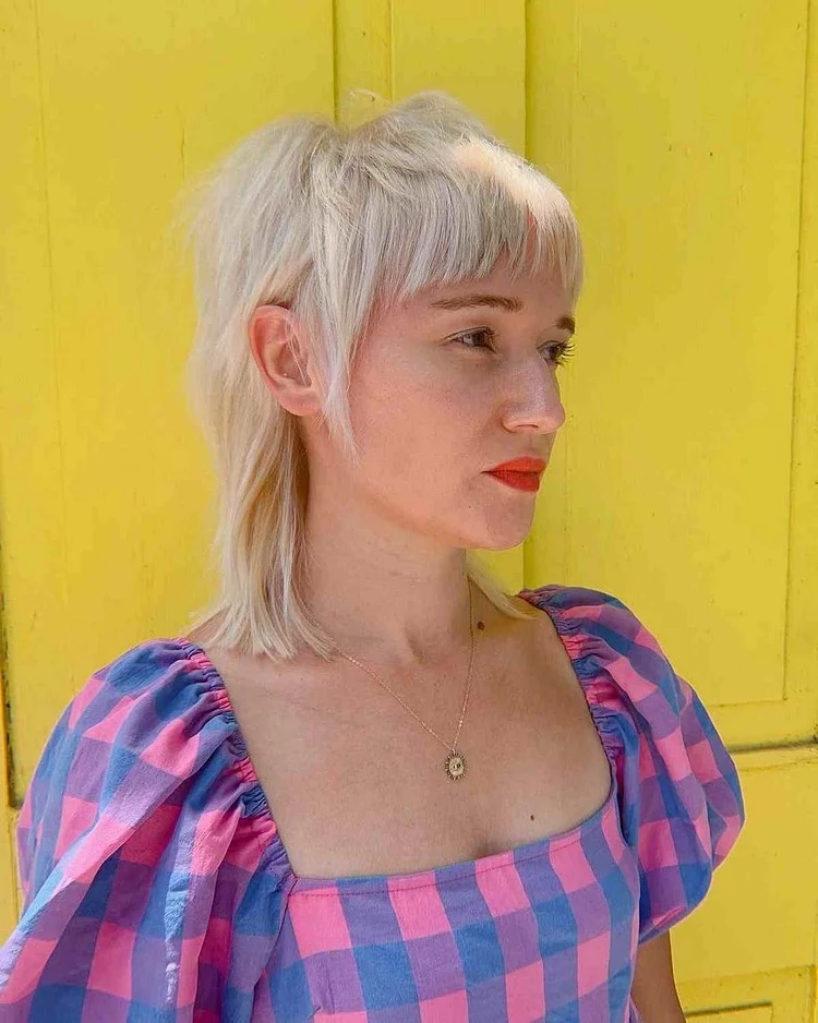 Platinum blonde with bangs for a vibrant look