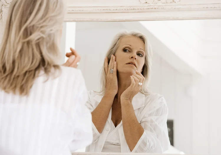 60 year old women apply makeup Skin care for women over 60 necessary routine moisturizing cream