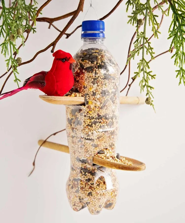 bird feeder made of a plastic bottle wooden spoons