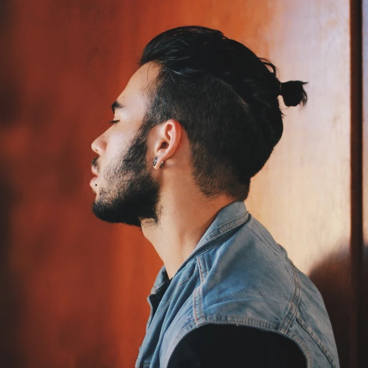 casual men hairstyle trends 2023 like a man bun for longer hair