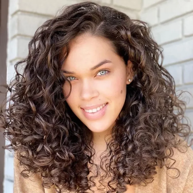 layered medium length hairstyles for curly hair trends 2023