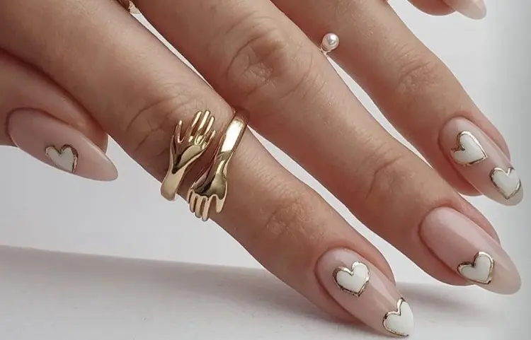 nude nails with white hearts and gold nail design valentines day