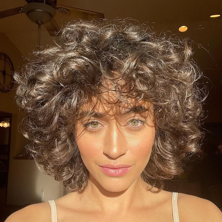 short bob for curly hair with layers and bangs style 2023