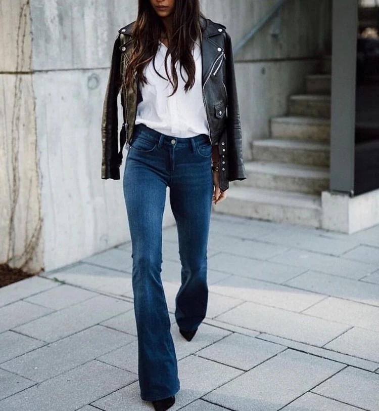 A crisp white top goes perfectly with flared pants and a leather jacket