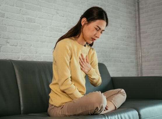 Young female suffering from heartburn