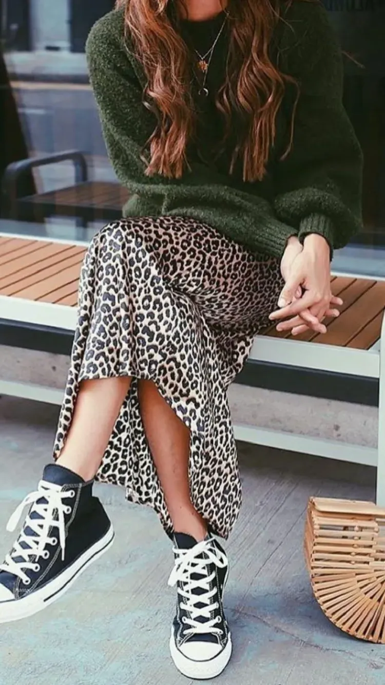 bohemian leopard skirt worn with a pair of Converse and a cozy sweater