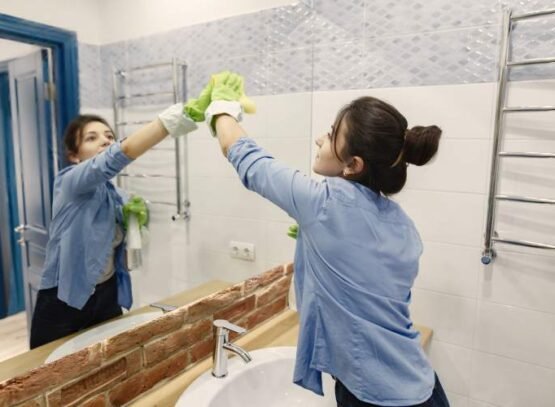 Woman with sponge and rubber gloves cleaning house