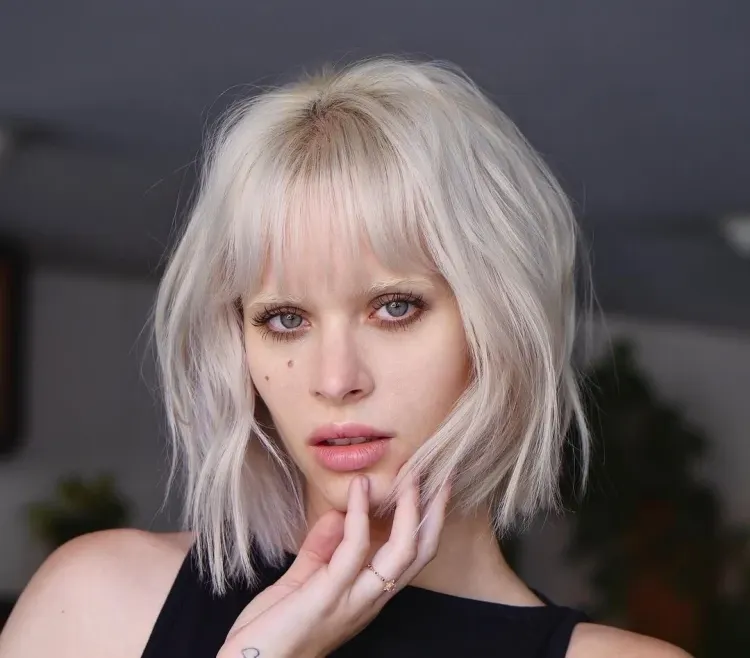 gorgeous platinum blonde chunky layered bob with blunt bangs