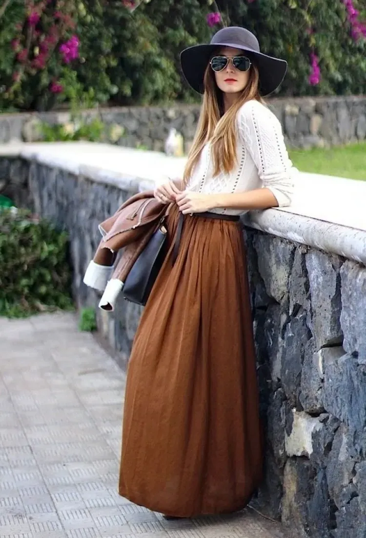 long brown boho skirt white sweater and a hat