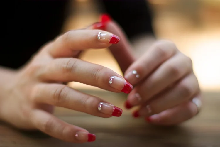 modern version of the classic French manicure with red tips