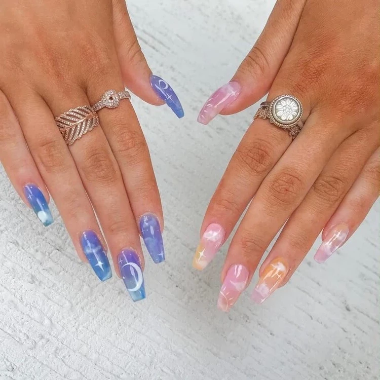 nail art according to zodiac sign pink and blue patterns stars half moon sun