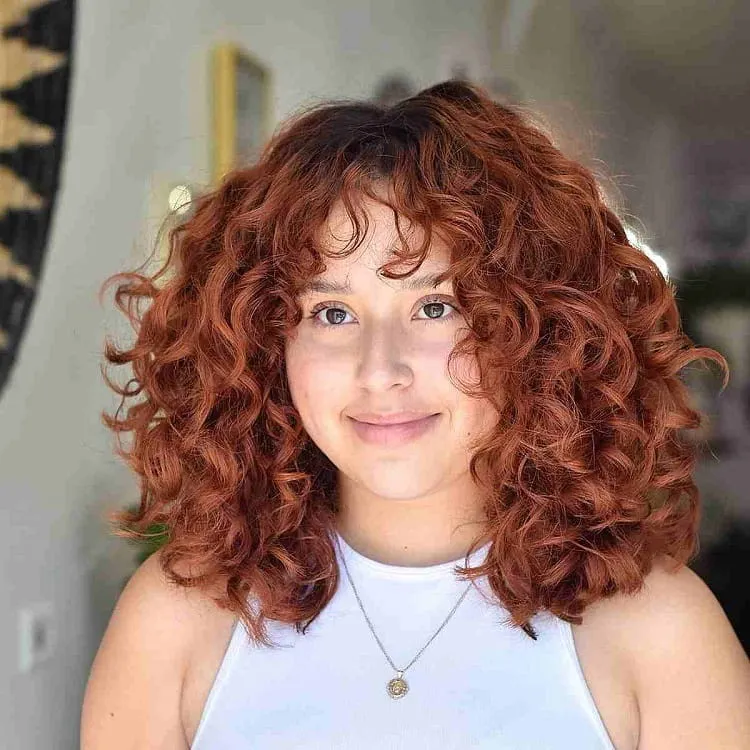 red-curls-with-wispy-bangs-haircut