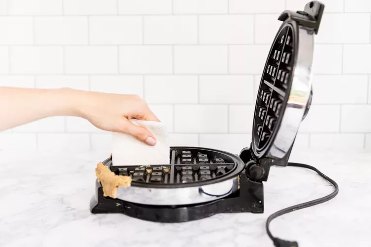use folded kitchen paper or cloth to clean the waffle maker