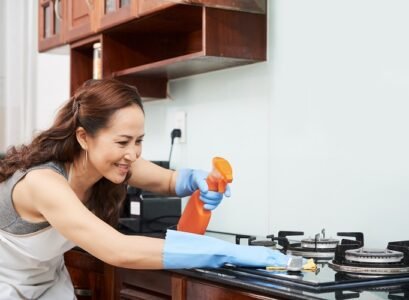 Housewife cleaning stove
