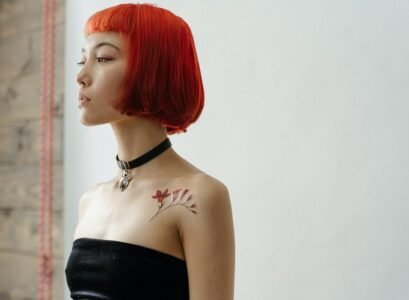 asian girl with french bob with bangs red hair