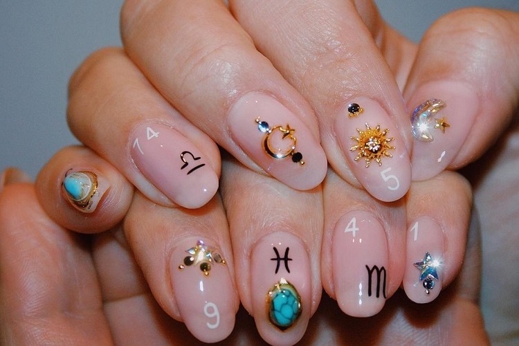 bejewelled astrology nails almond shape nail decoration inspiration