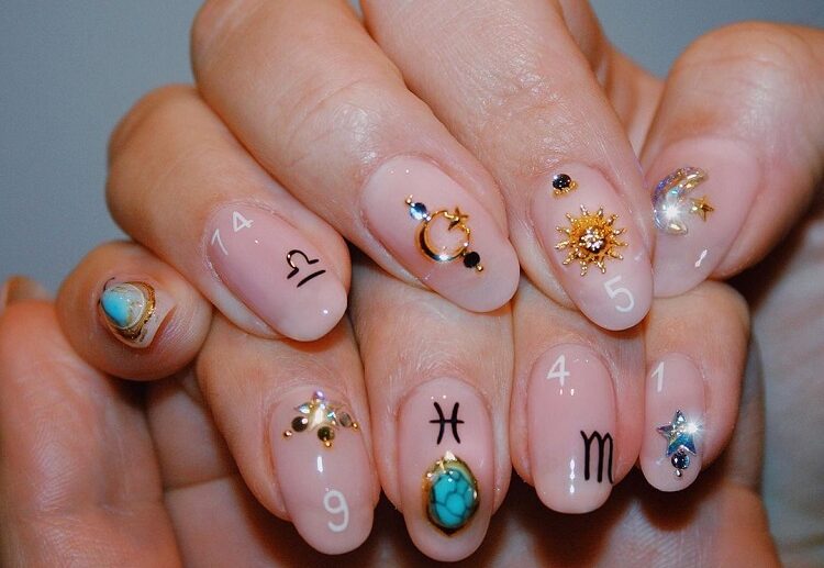 bejewelled astrology nails almond shape nail decoration inspiration