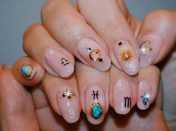 bejewelled astrology nails almond shape nail decoration inspo