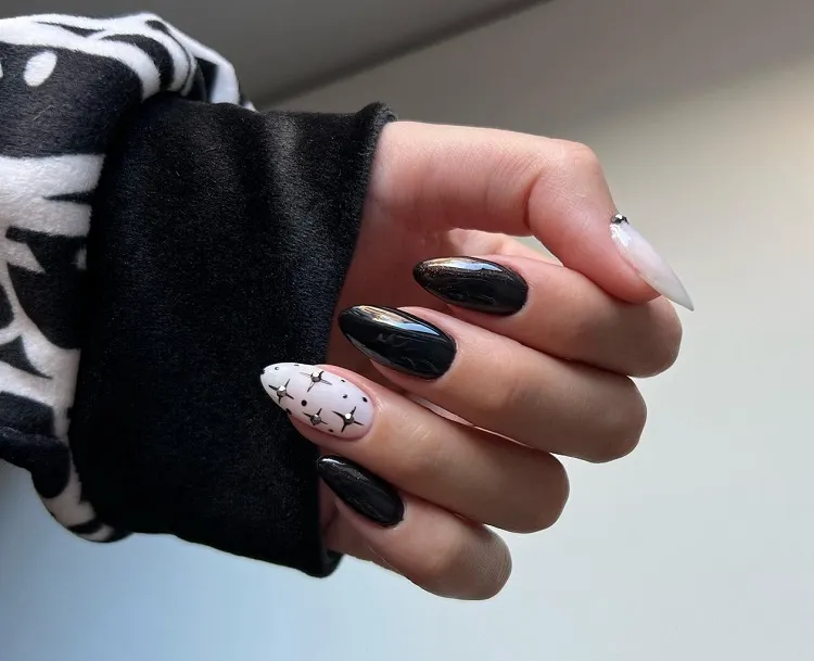black nails with white decoration chrome stars manicure art