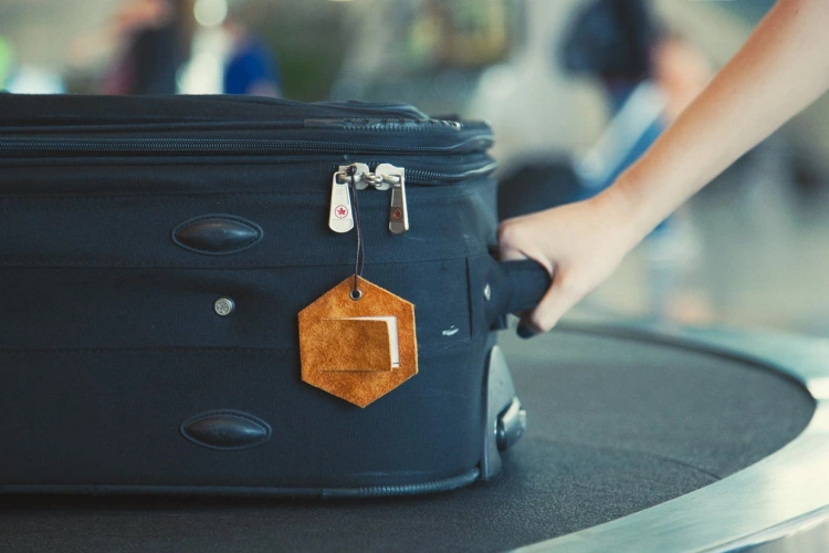 brown leather luggage tag on a suitcase at the airport