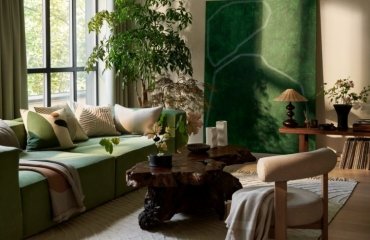 green accent sofa artwork plants beige living room decoration