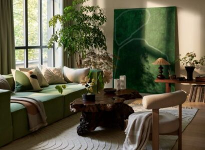 green accent sofa artwork plants beige living room decoration