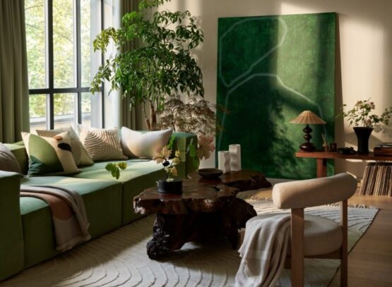 green accent sofa artwork plants beige living room decoration