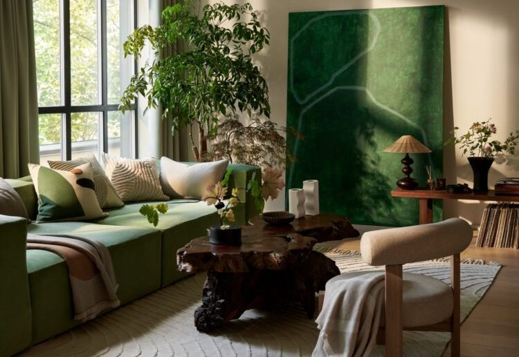 green accent sofa artwork plants beige living room decoration