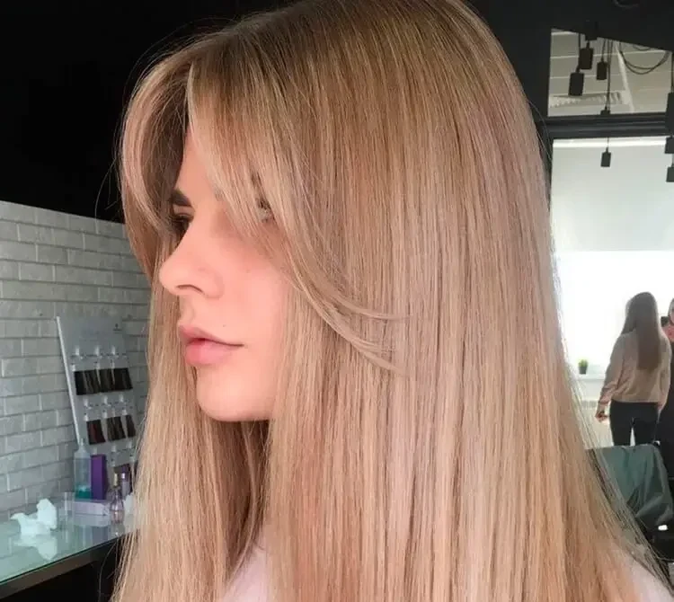 long straight blonde hair and curtain bangs