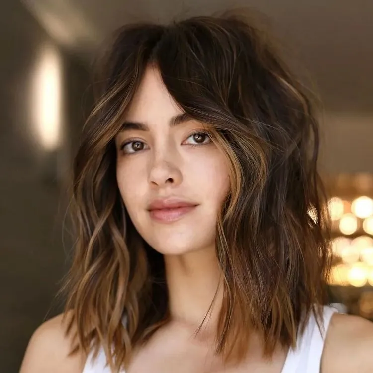 modern layered medium length hairstyle with a fringe