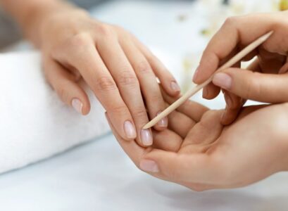 pushing back cuticles with special wooden stick