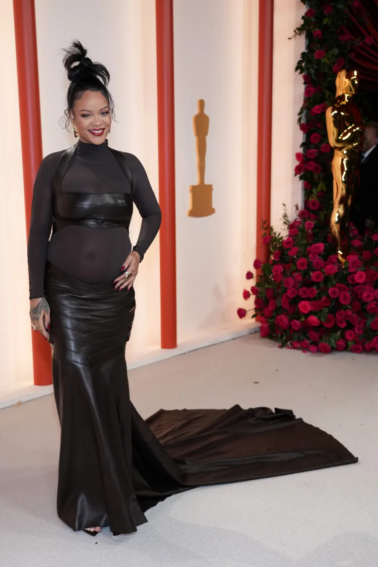 rihanna wearing a black fitted gown with leather details
