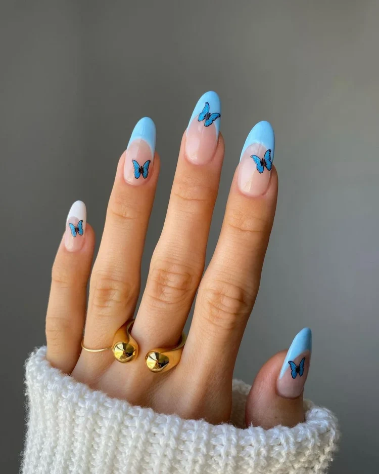 spring inspired nail design in blue and white with butterflies