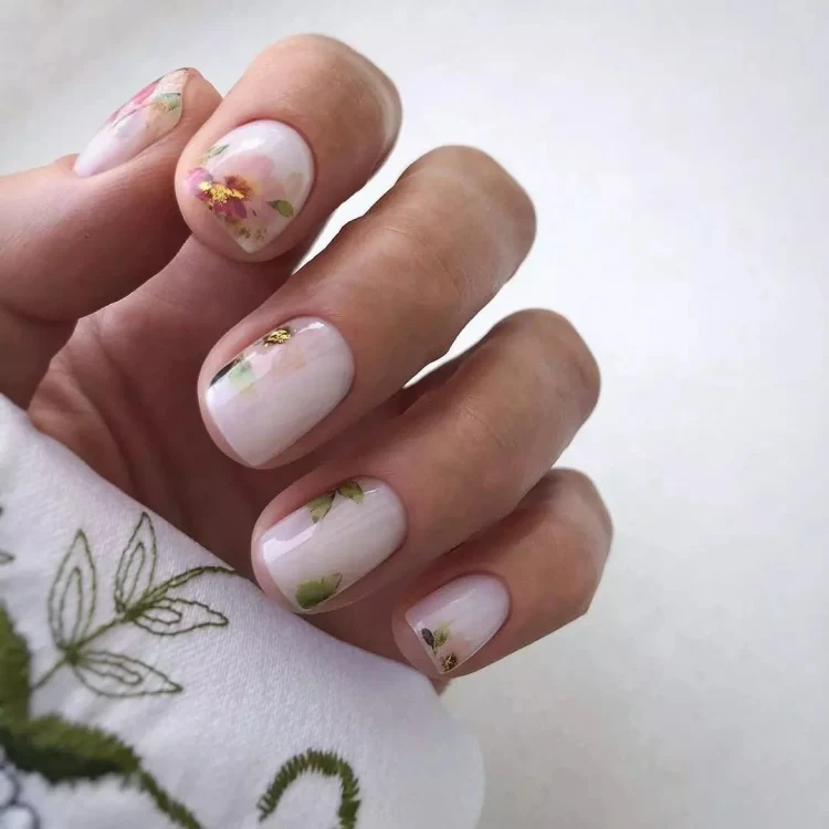 spring nail design idea aesthetic nails with flowers and leaves March nails 2023