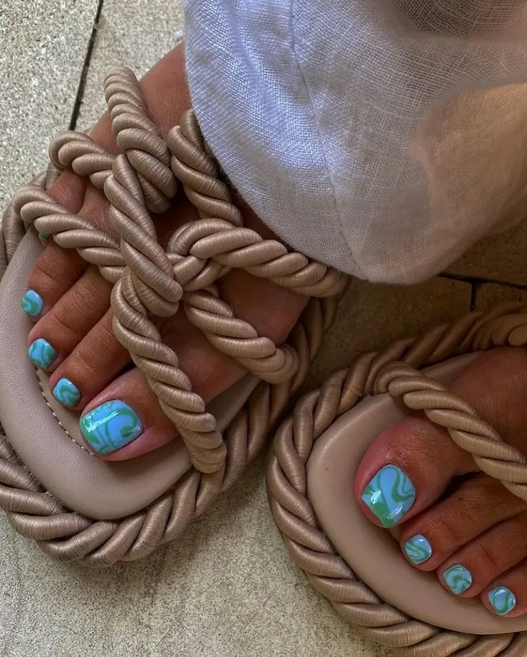 vobrant colors electric blue swirly toenails design trend 2023